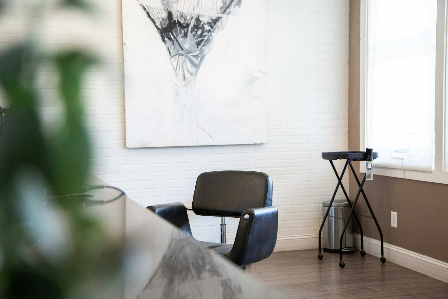 A private salon suite with a single styling chair and mirror in a calm, neutral room